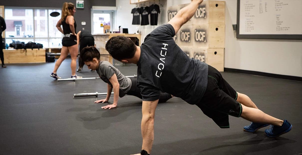 Coach at Orleans CrossFit working with a member during a Ramp-Up session
